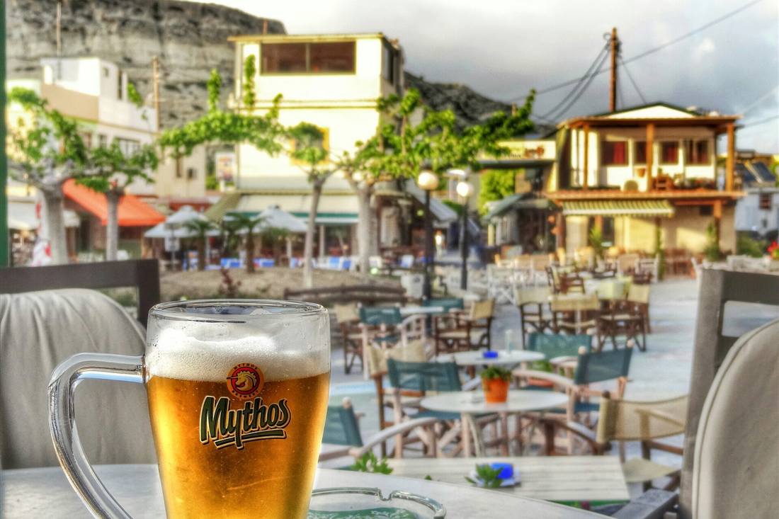 Crete beer tasting: a glass of Greek beer on a taverna table at Matala, Crete