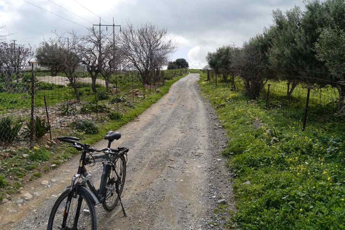 E-bike parked on a country track between olive trees near Amoudara, Heraklion, Crete