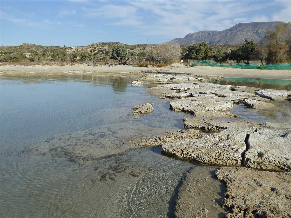 Clear shallow water over limestone shelves at Elafonisi on the south-west coast of Crete, a shore entry for Crete snorkeling