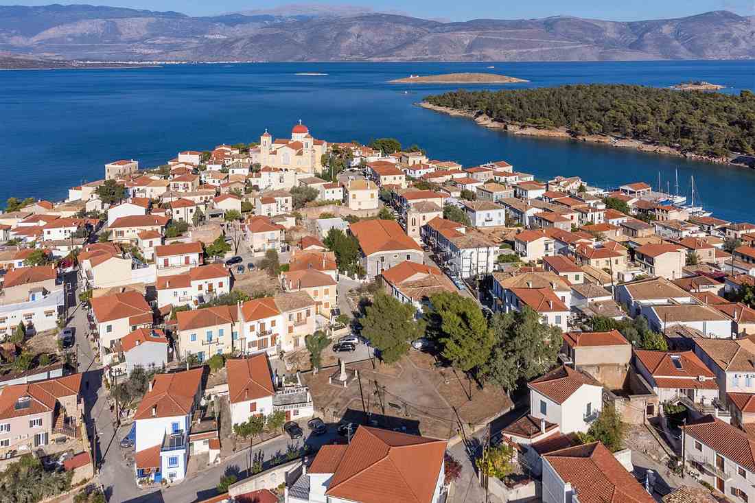 Galaxidi on its peninsula with the pine headland, the islets of the Gulf of Itea and the mountains beyond, the route of a Galaxidi boat tour