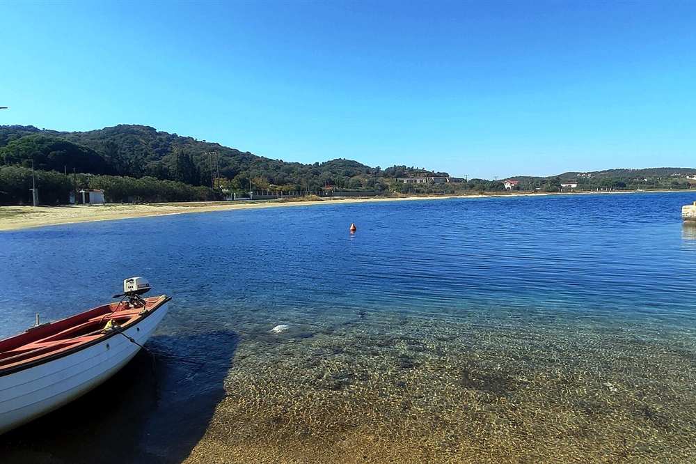 Clear shallow water and a moored boat at Ammouliani, the island the Blue Lagoon cruise calls at