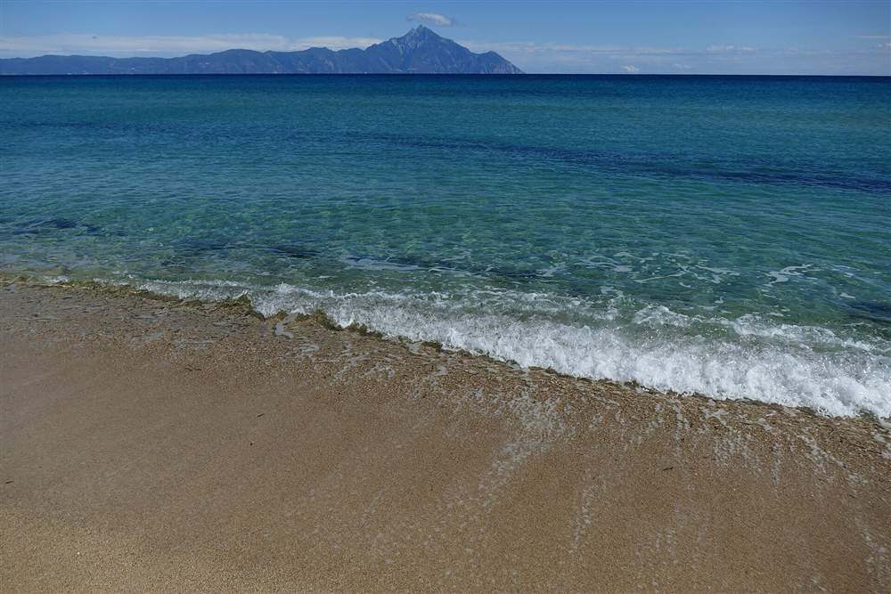 Mount Athos across the water from the Sithonia coast, the Halkidiki landmark above the tasting villages