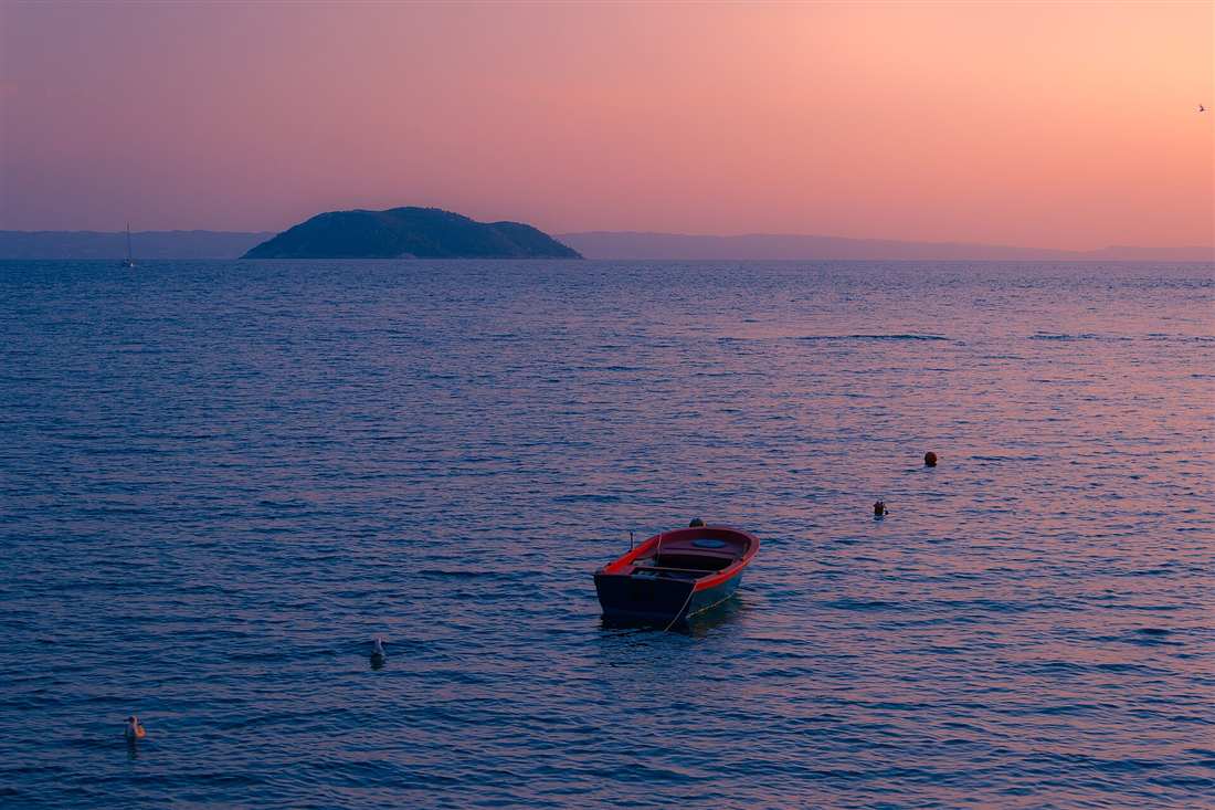 The Kelyfos islet off the Sithonia coast of Halkidiki at dusk, a landmark dive site for Halkidiki scuba diving