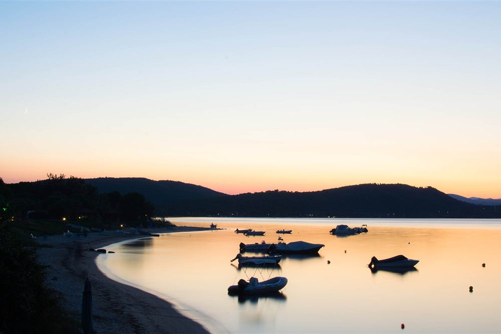 Boats at anchor in the bay of Vourvourou, Sithonia, at dusk