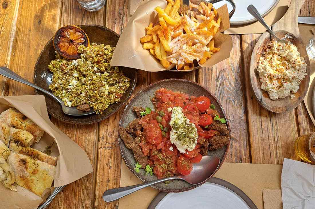 Cretan dakos salad with meze plates on a Heraklion food tour