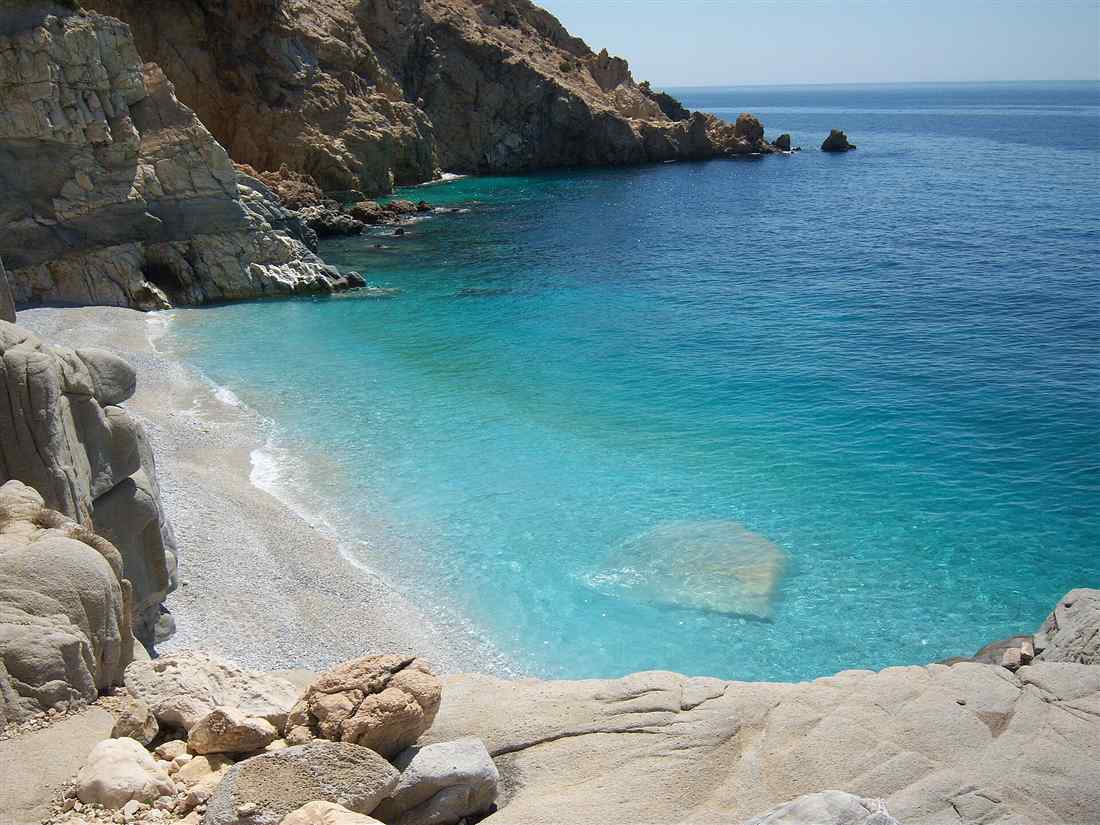 The turquoise cove of Seychelles beach on Ikaria, the island reached by airport transfers from Ikaria Airport