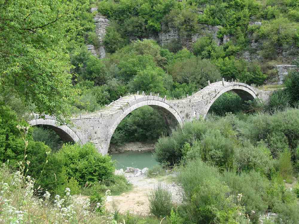A stone-arched bridge over a river in the Zagori region near Ioannina, Greece
