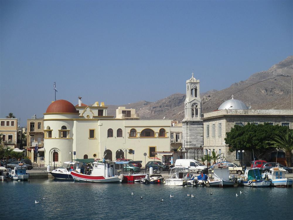 The harbour of Pothia on Kalymnos with its domed church and clocktower above the moored fishing boats