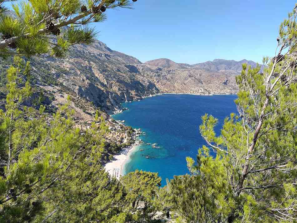 The turquoise cove of Apella beach on Karpathos, the island reached by airport transfers from Karpathos Airport