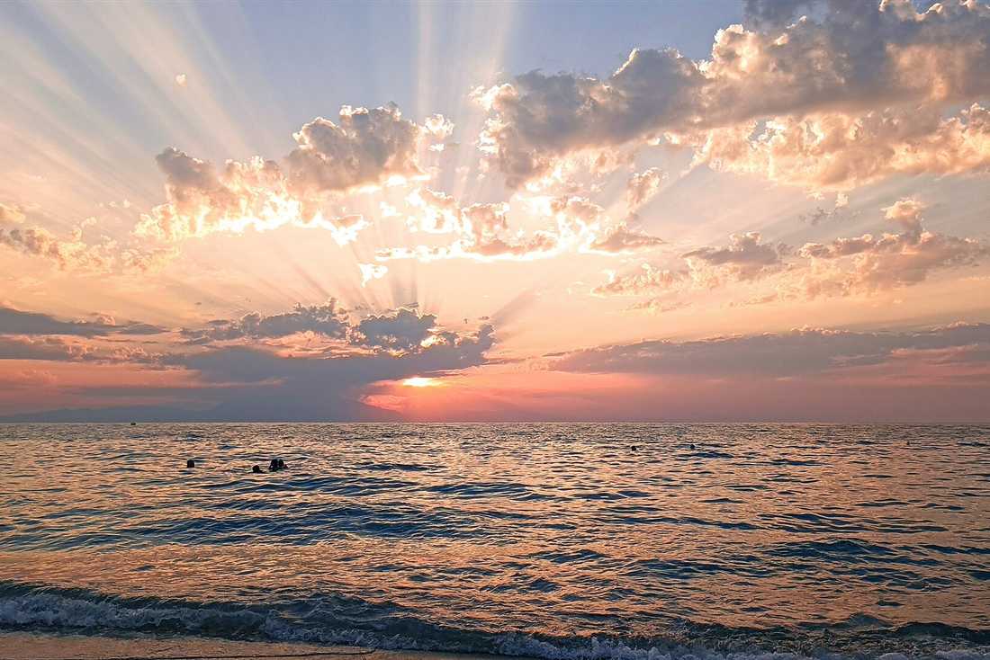 Sunset over the sea at Possidi on the west coast of Kassandra Halkidiki, with sunrays breaking through the cloud