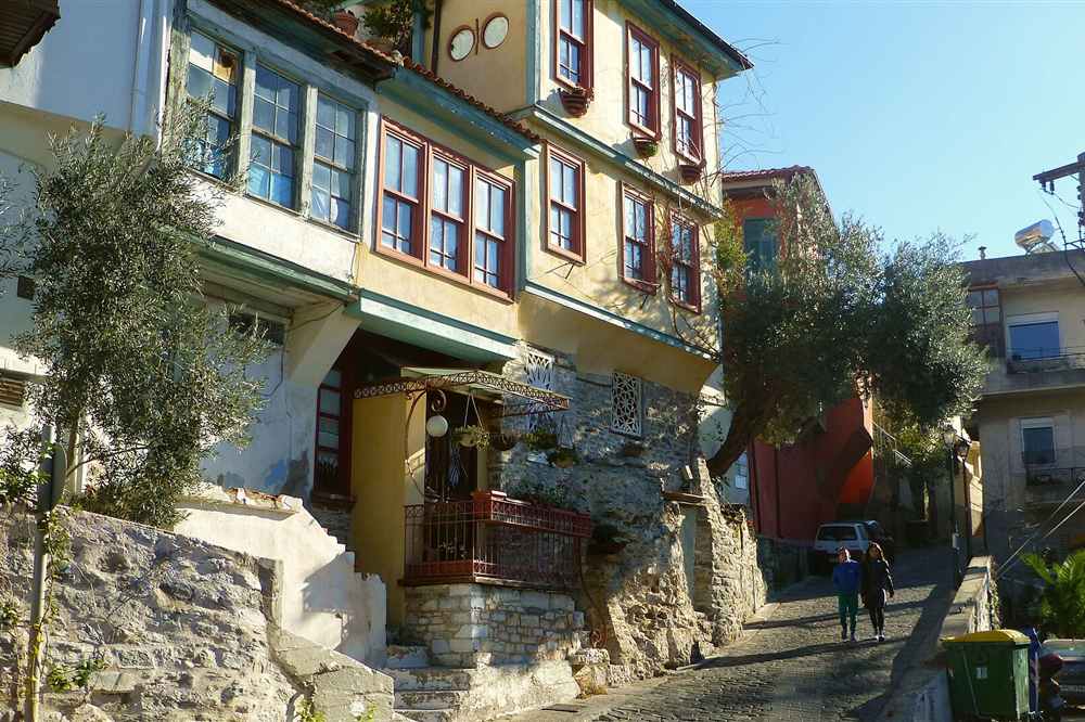 Ottoman-era houses with wooden balconies on a steep lane of the Kavala old town