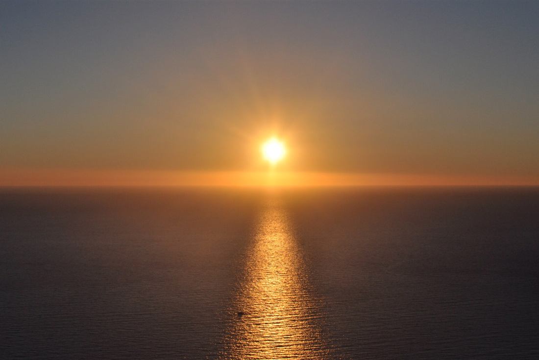Kefalonia sunset cruise: the sun setting over the Ionian beside the Assos peninsula