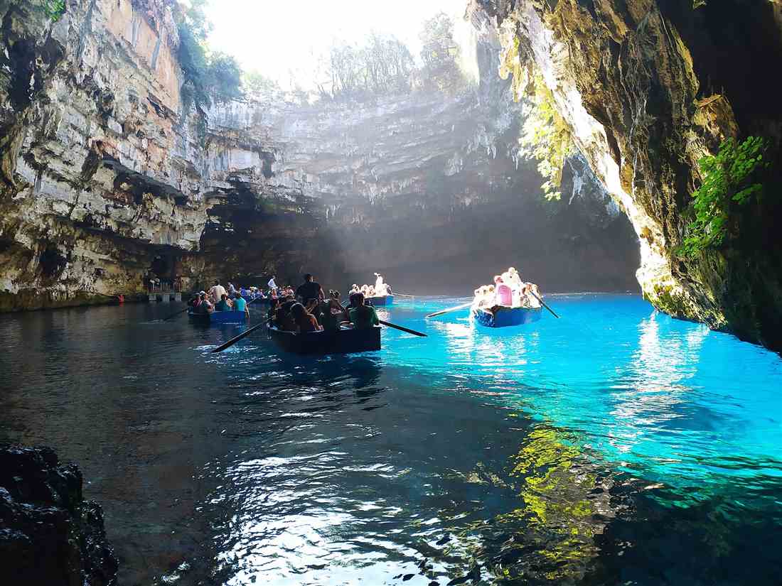 Rowing boats on the turquoise underground lake of the Melissani cave on Kefalonia