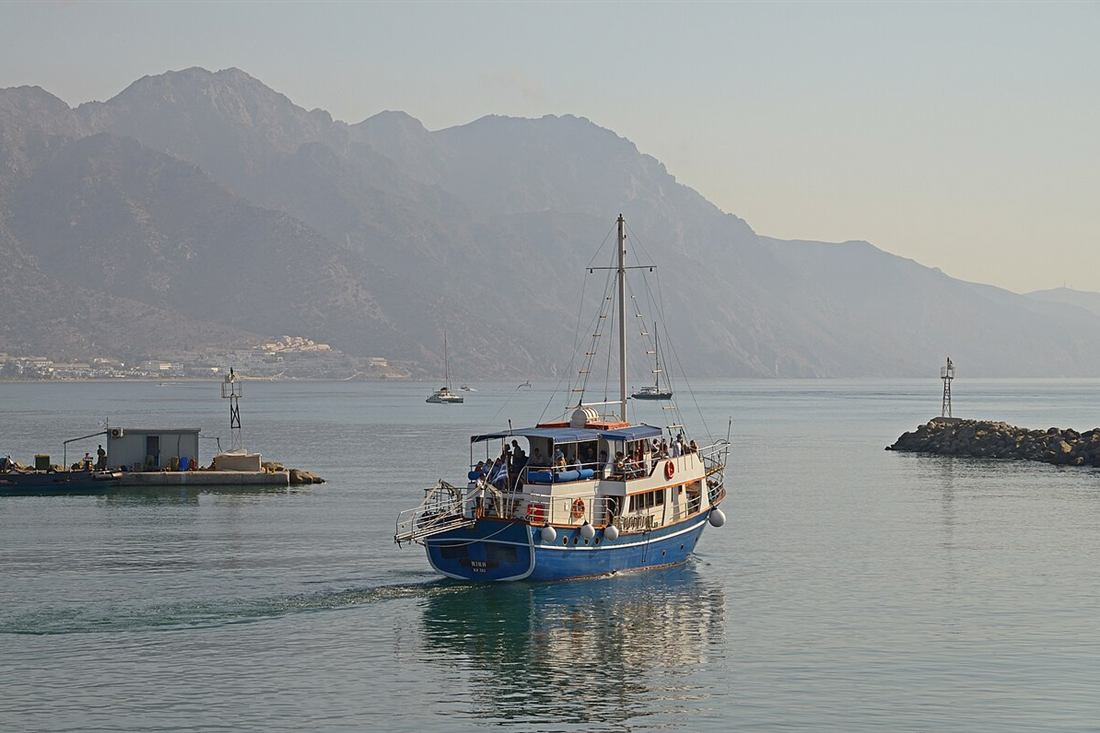 A small day boat leaving Kardamena harbour on Kos in the early morning
