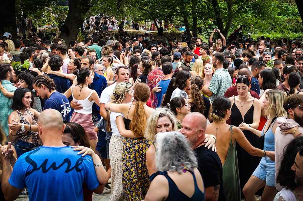 Dancers filling the floor at a Greek village feast under the plane trees