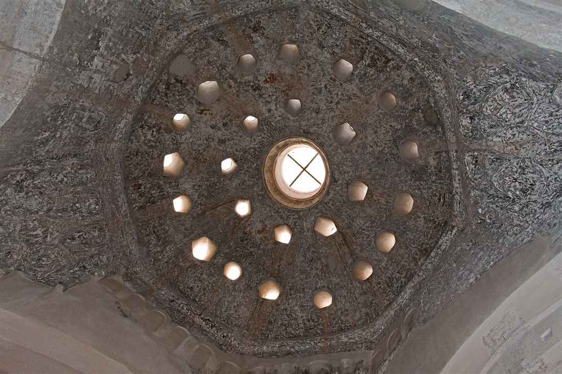 Kos hammam: light falling through the star-shaped openings of a domed Ottoman bath ceiling in Greece