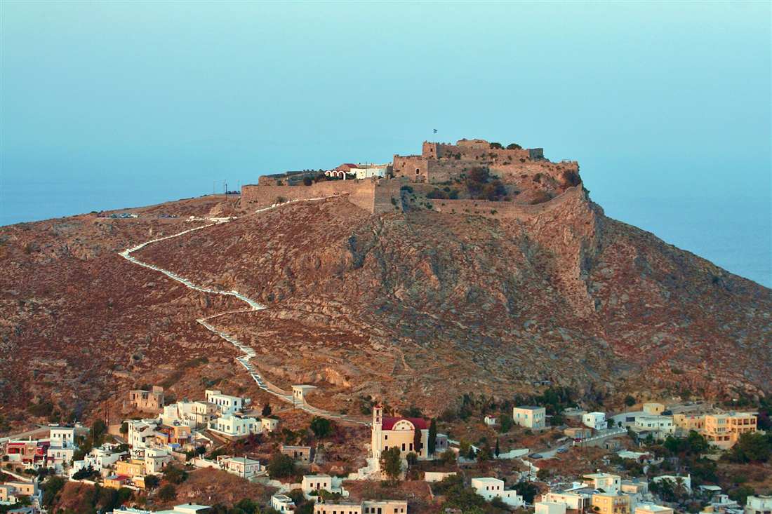 The castle of Pandeli above the town of Platanos and Agia Marina on Leros at golden hour, above a Leros yacht charter base