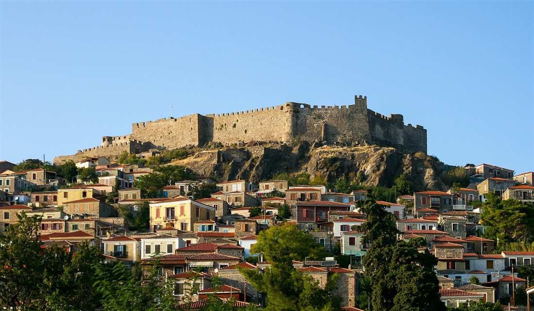 The hilltop castle above the stone village of Molyvos on Lesvos, reached by airport transfers from Mytilene Airport