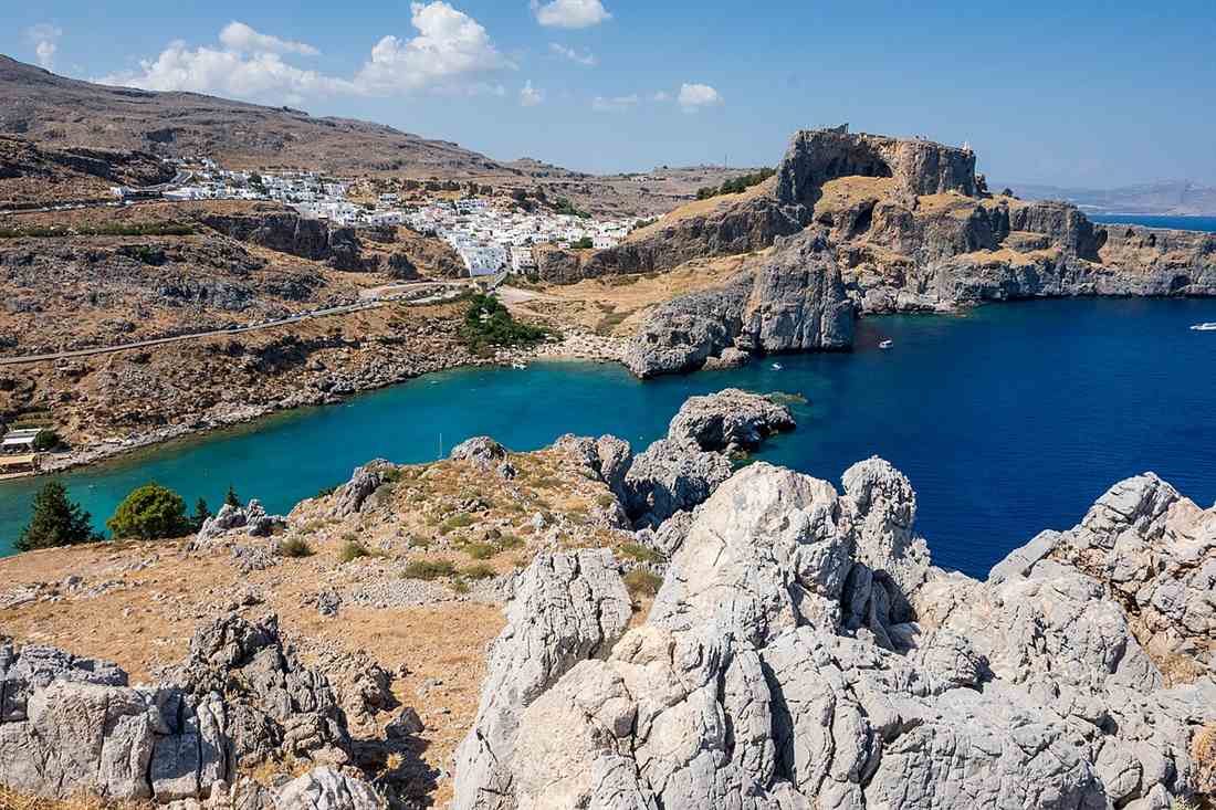 Lindos village and its acropolis above St Pauls Bay on Rhodes