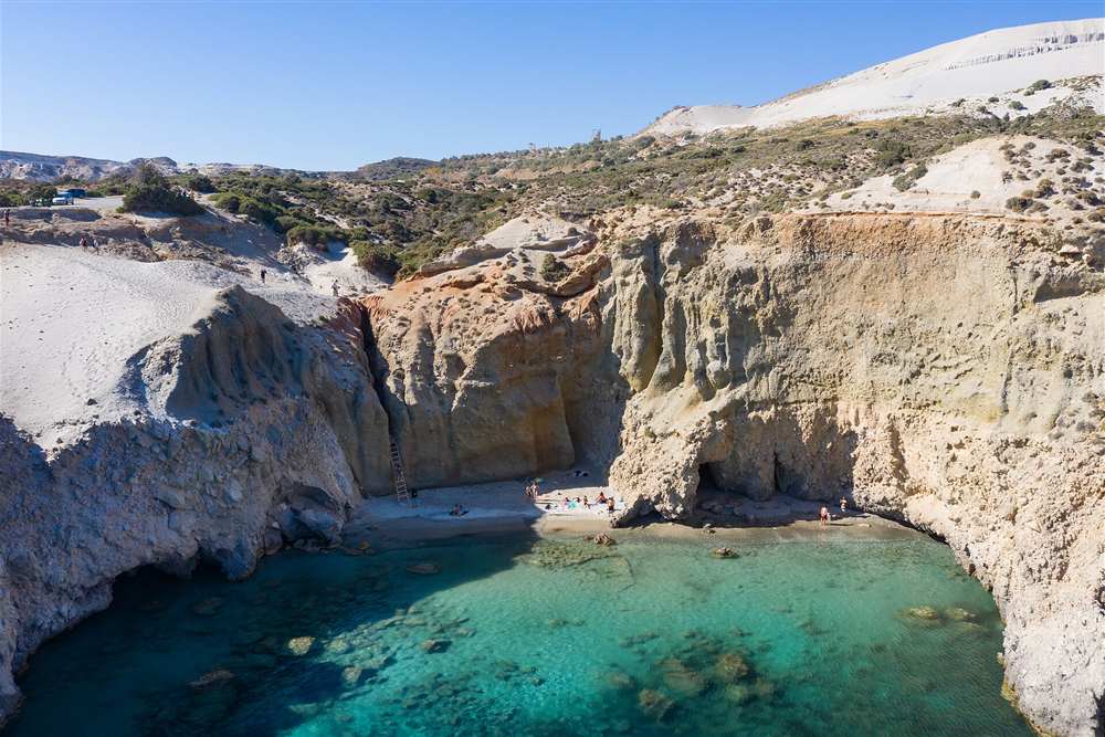 Aerial view of Tsigrado beach and its cove on the south coast of Milos