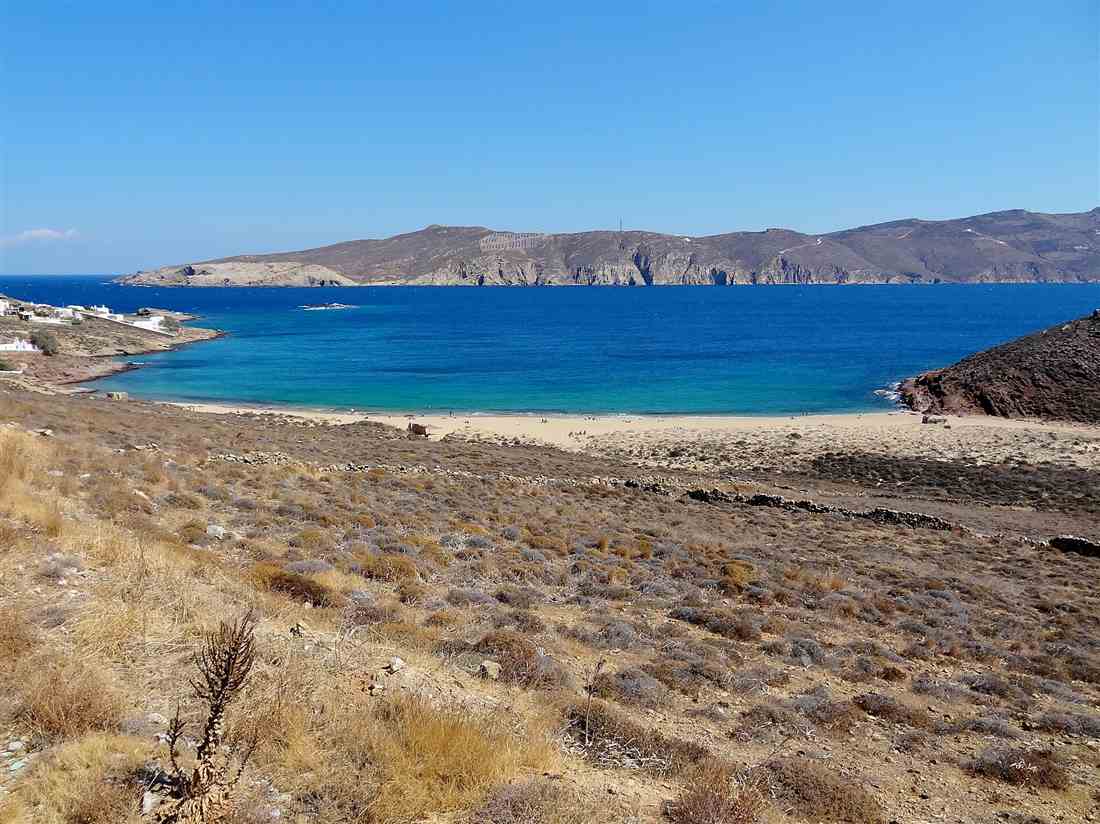 The turquoise bay and sand of Agios Sostis on the north coast of Mykonos, reached by the dirt track a Mykonos ATV quad tour follows