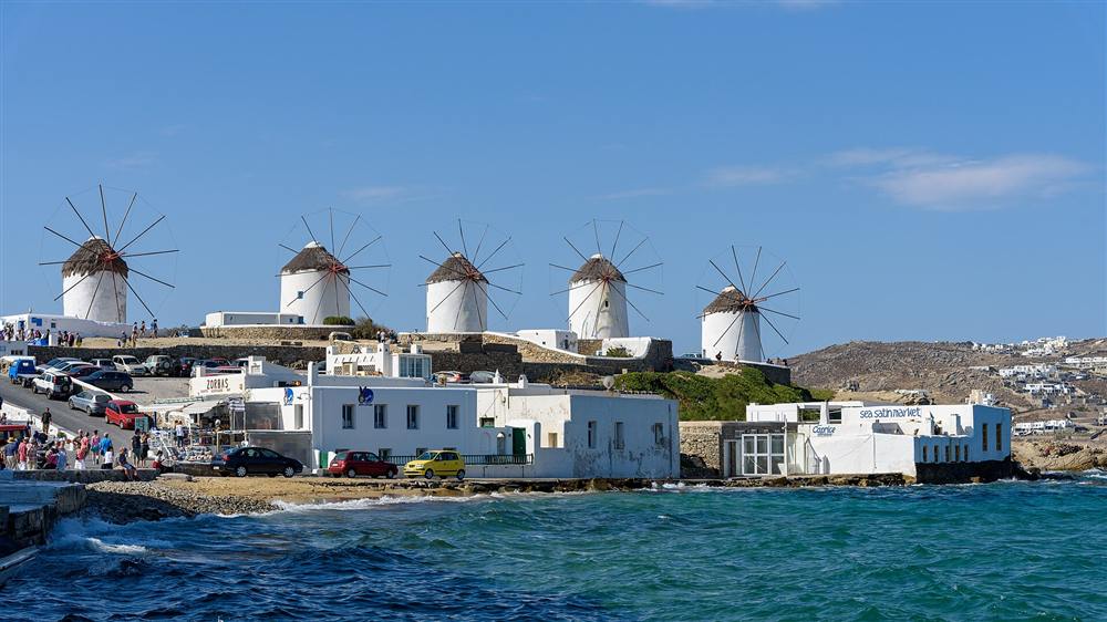 The windmills of Kato Mili above the waterfront of Mykonos town