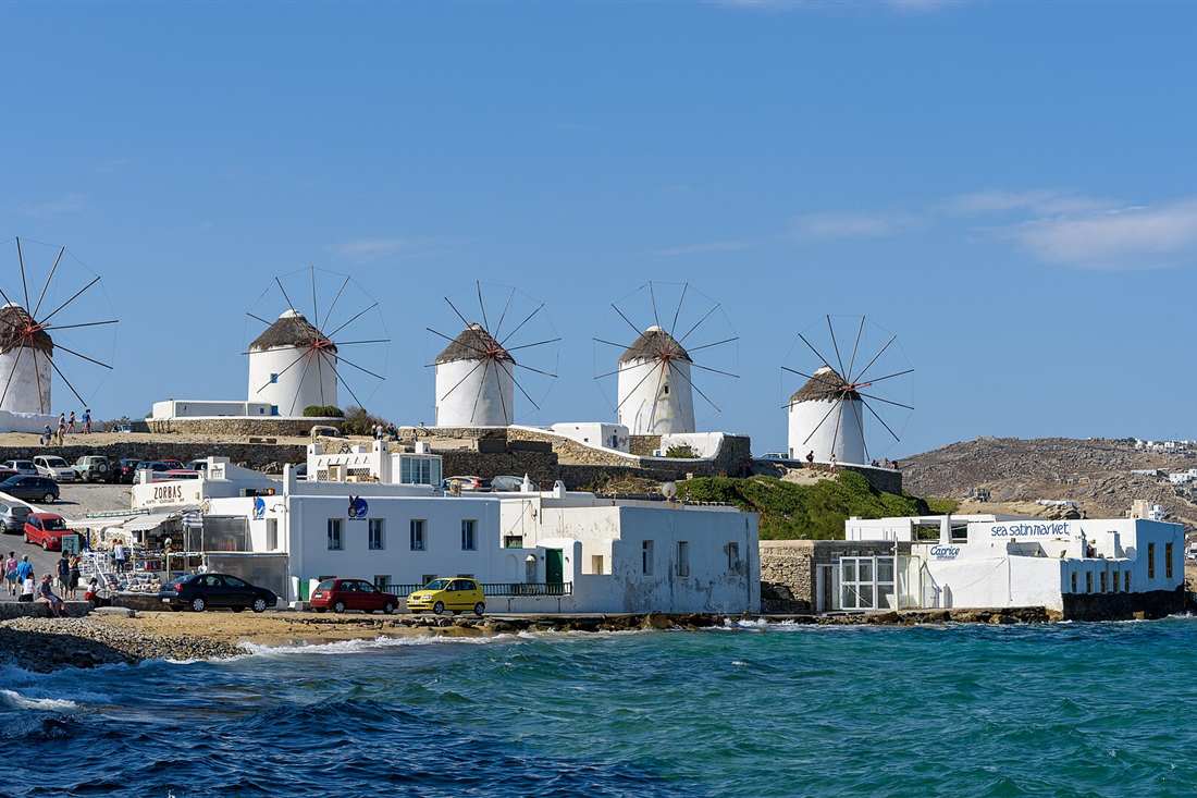 The five windmills of Kato Mili seen from the sea on a Mykonos boat rental