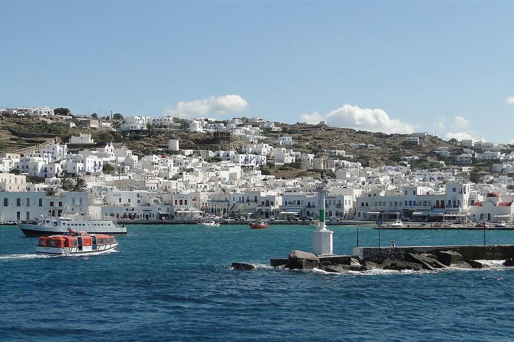 The old port of Mykonos with day boats alongside the town waterfront