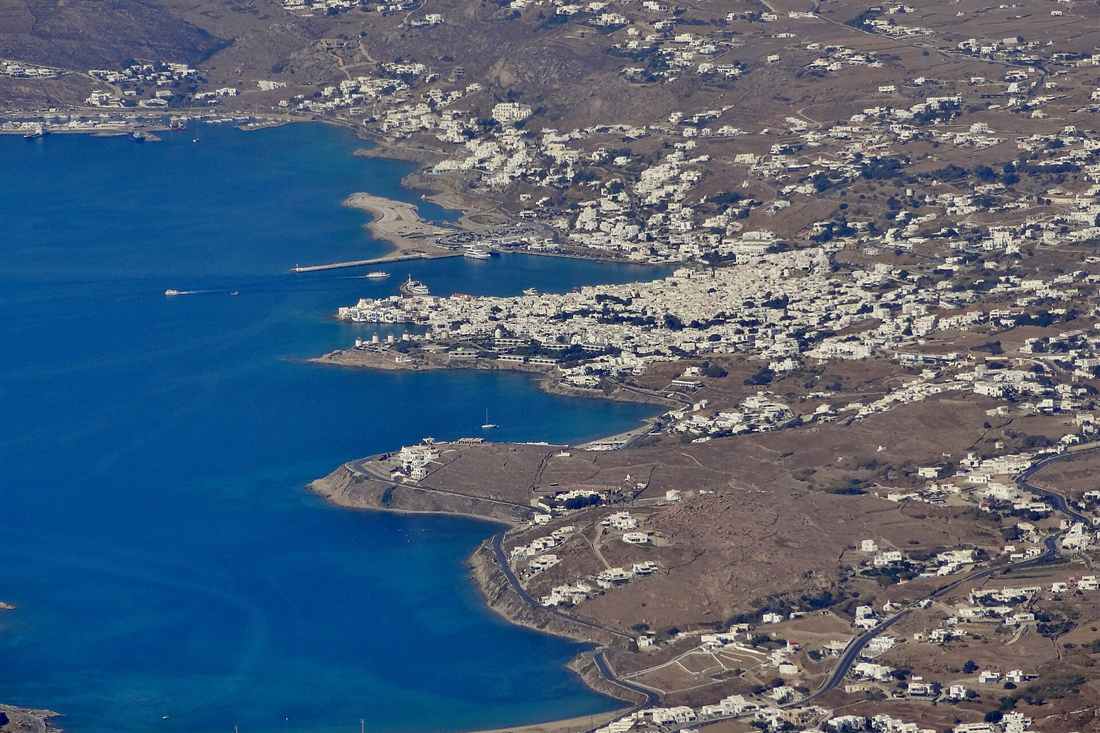 Mykonos Town, the old port and the windmill headland seen from the air, the view a Mykonos helicopter tour delivers