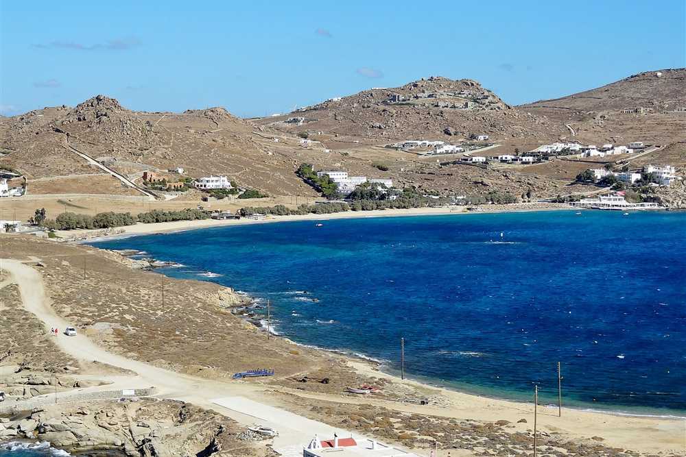 The blue bay and long beach of Kalafatis on the east coast of Mykonos