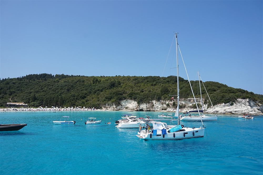 Voutoumi bay on Antipaxos with the white cliffs behind and the cruise boats at anchor, the second swimming call of the day