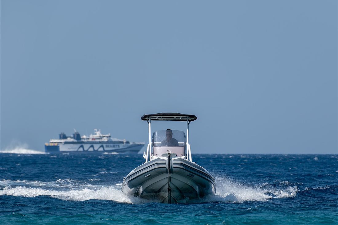 A hire boat underway in the Cyclades, the rigid inflatable a Paros boat rental puts you in charge of