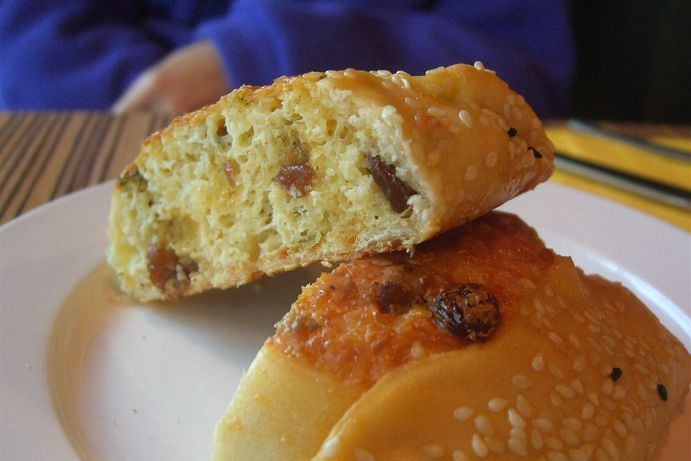 A cheese and herb pie cut open on a plate, the bakery tasting on the village leg of the walk