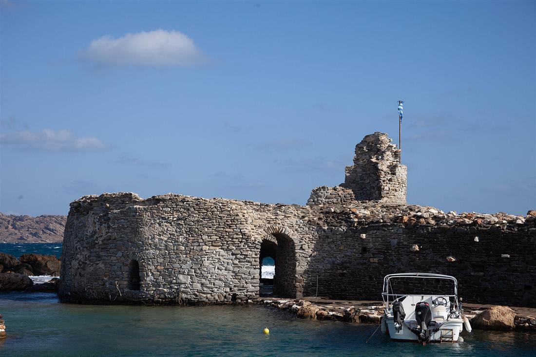The ruined Venetian castle standing in the clear water at the entrance to Naoussa harbour on Paros, where the boats leave for Paros snorkeling
