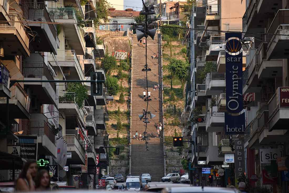 Patras city tour walkers climbing the Agiou Nikolaou staircase