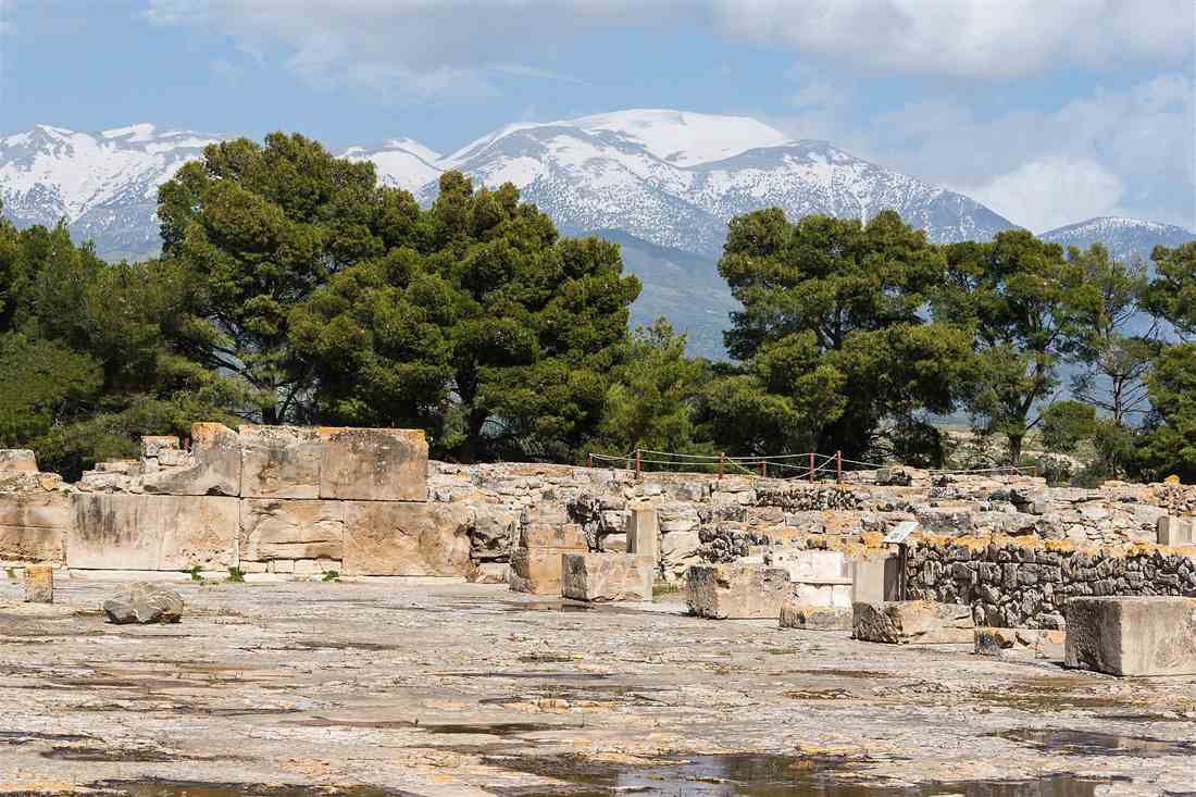 Phaistos tour view across the central court of the Palace of Phaistos to snow-capped Psiloritis