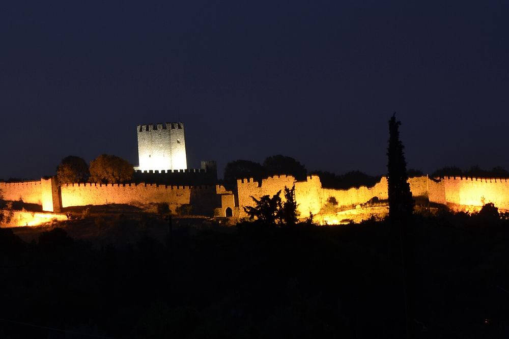 Platamonas castle lit at night above the Thermaic Gulf