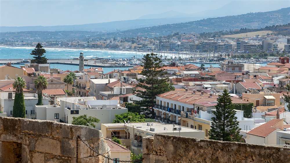 The old town of Rethymno, its Venetian lighthouse and harbour seen from the Fortezza walls