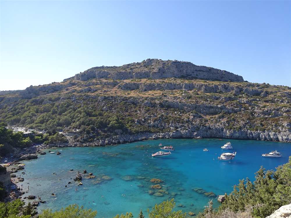 The turquoise water and wooded headland of Anthony Quinn Bay on the east coast of Rhodes