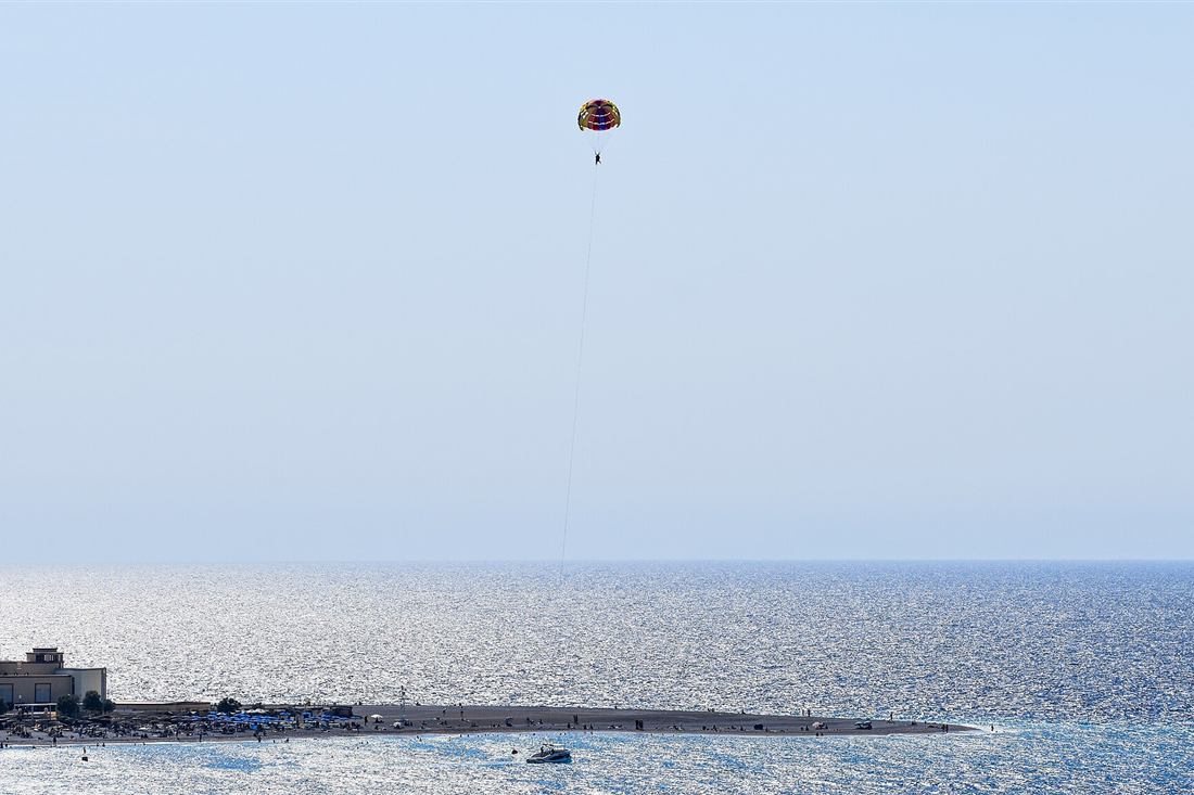 Parasailers flying above Elli beach and the Aquarium of Rhodes on a Rhodes parasailing flight