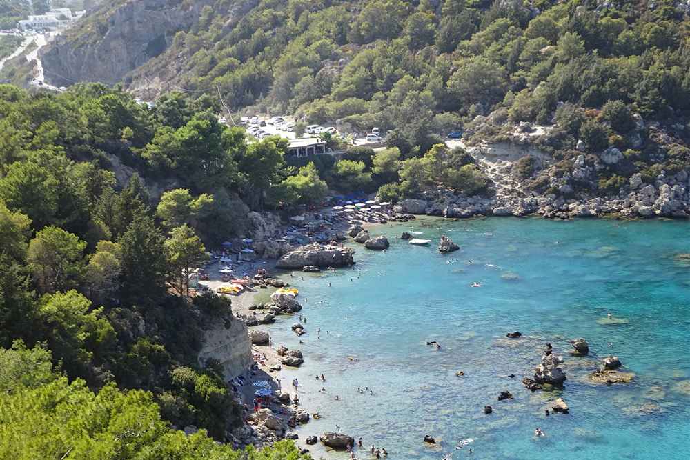 Turquoise water and pine-covered limestone at Anthony Quinn Bay beside Ladiko, Rhodes