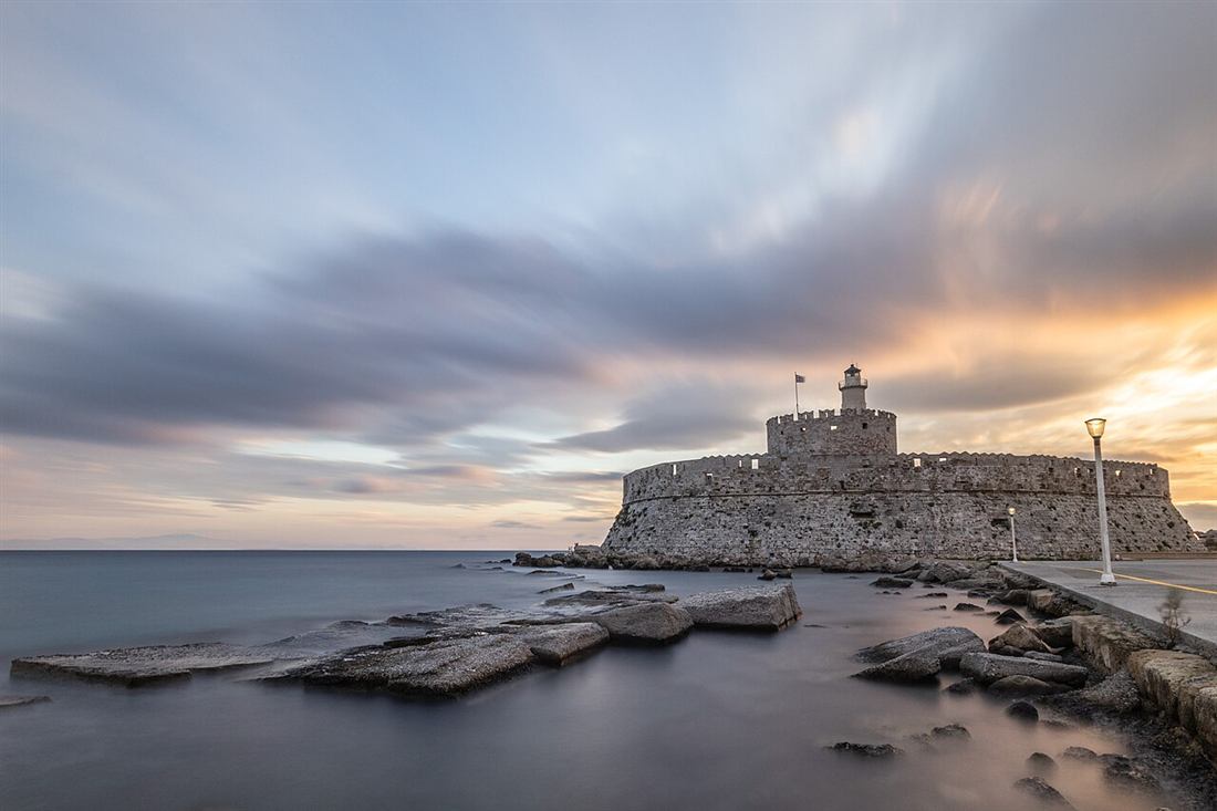 The fort of Saint Nicholas at the mouth of Mandraki harbour, Rhodes, at dusk
