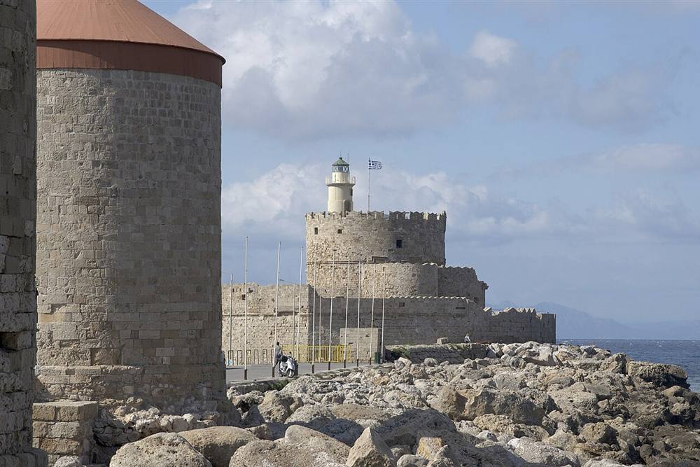 A Mandraki windmill and the fort of Saint Nicholas on the harbour mole at Rhodes