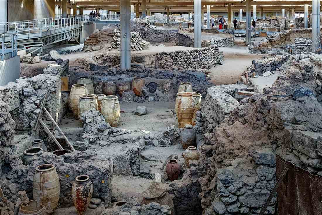 Santorini Akrotiri tour: the Bronze Age storerooms with their pithoi under the shelter roof
