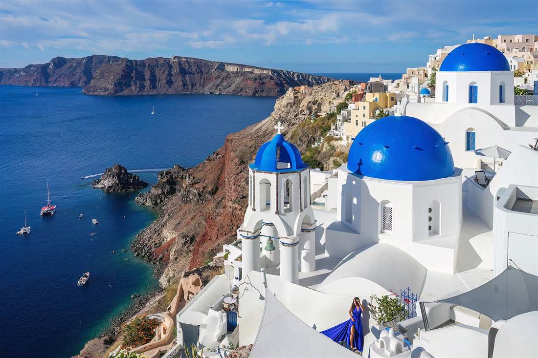 The blue domes of Oia above the caldera, the signature stop on a Santorini half day private tour