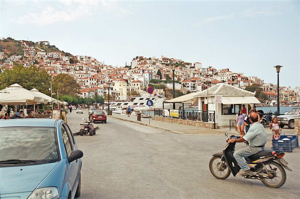 The white houses of Skopelos Town rising in an amphitheatre above the harbour