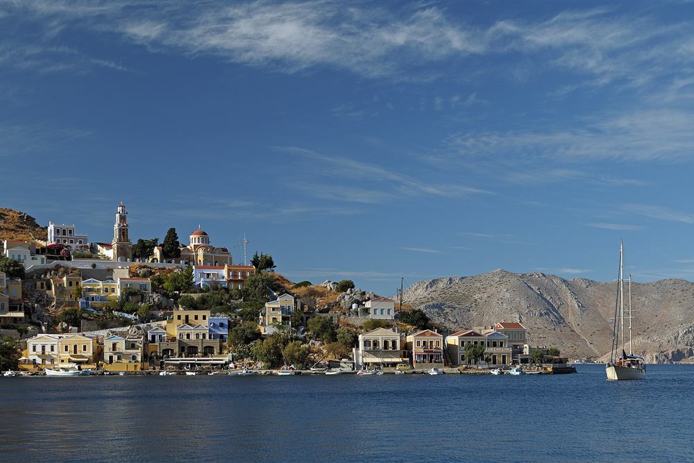 Panorama of Symi harbour and the upper town under the bare Dodecanese hills