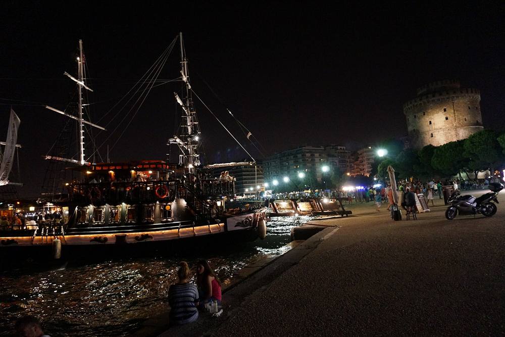 Thessaloniki sunset cruise bar boat moored by the White Tower at night