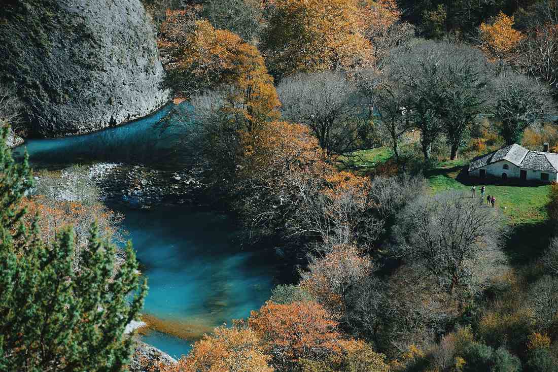 The turquoise pool of the Voidomatis below the Vikos gorge in autumn, the water a Voidomatis river rafting run crosses