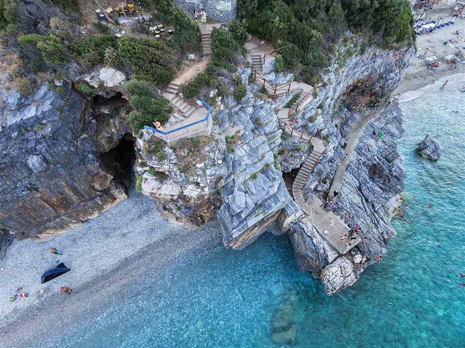 The marble rock arch and turquoise water of Mylopotamos beach in Pelion near Volos, reached by airport transfers from Volos Airport